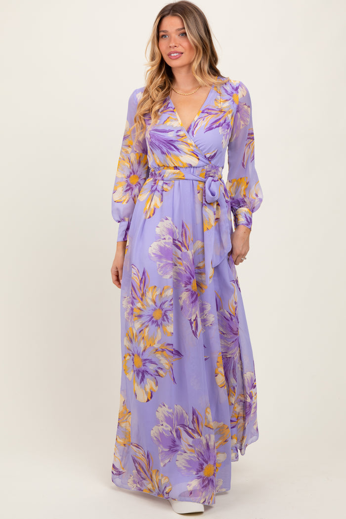 woman wearing a lavender floral maxi dress with long sleeves and a tie waist detail