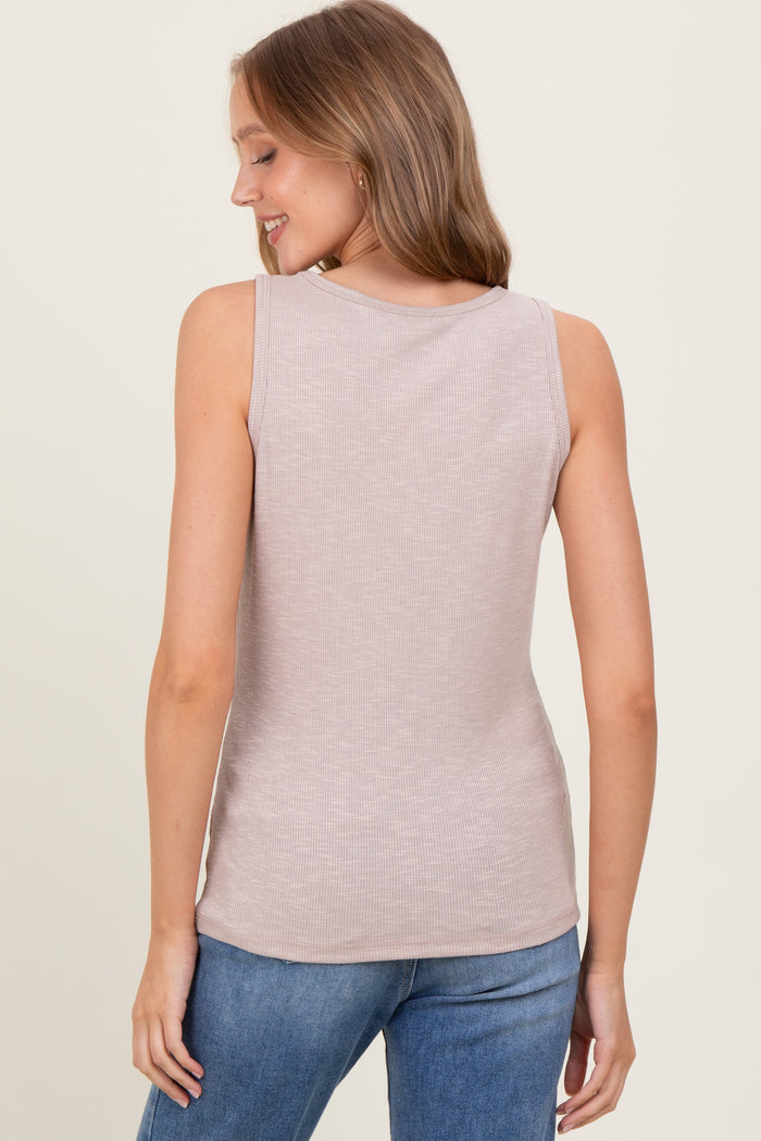 woman wearing a light beige sleeveless ribbed top, view from the back, paired with blue jeans