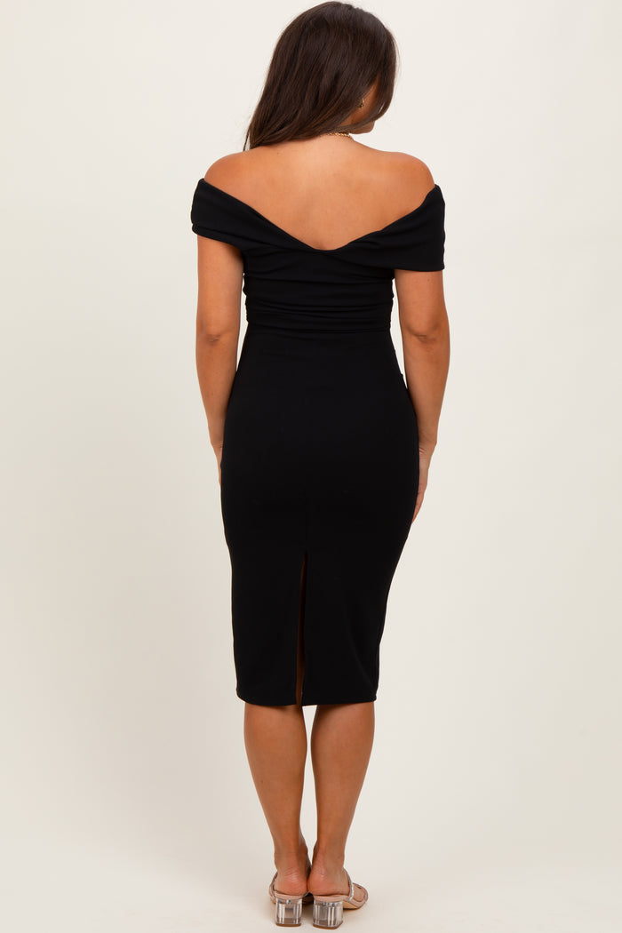 woman wearing a black off-shoulder maternity dress with a fitted silhouette and a back slit