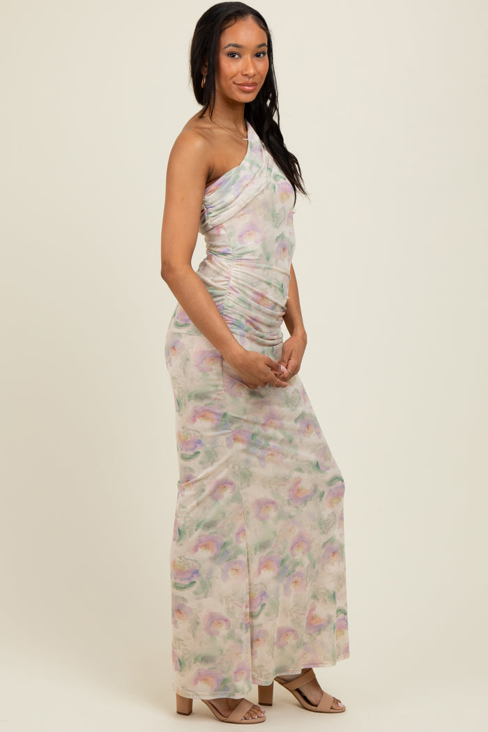 woman wearing a pastel one-shoulder dress with ruched detailing and a flowing silhouette