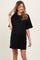 woman wearing a black oversized t-shirt dress showing her baby bump in maternity wear