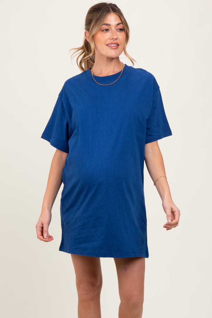 woman wearing a blue short sleeve maternity t-shirt dress with a visible baby bump