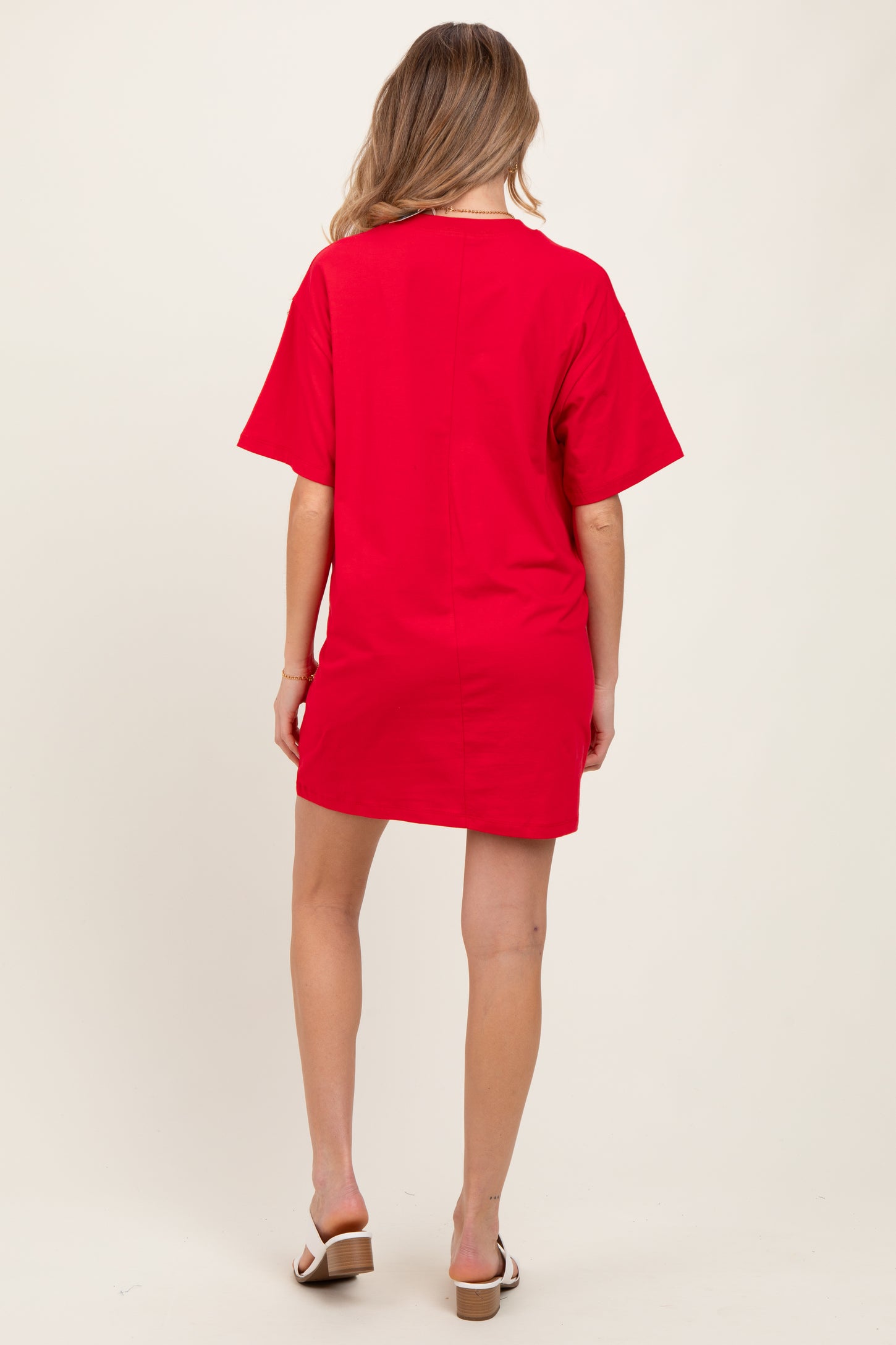 woman wearing a red short sleeve maternity dress, shown from the back