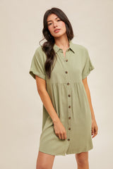 woman wearing a short sleeve light green button-up dress with a relaxed fit and tiered skirt