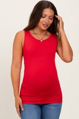 woman wearing a red maternity tank top and showing her baby bump