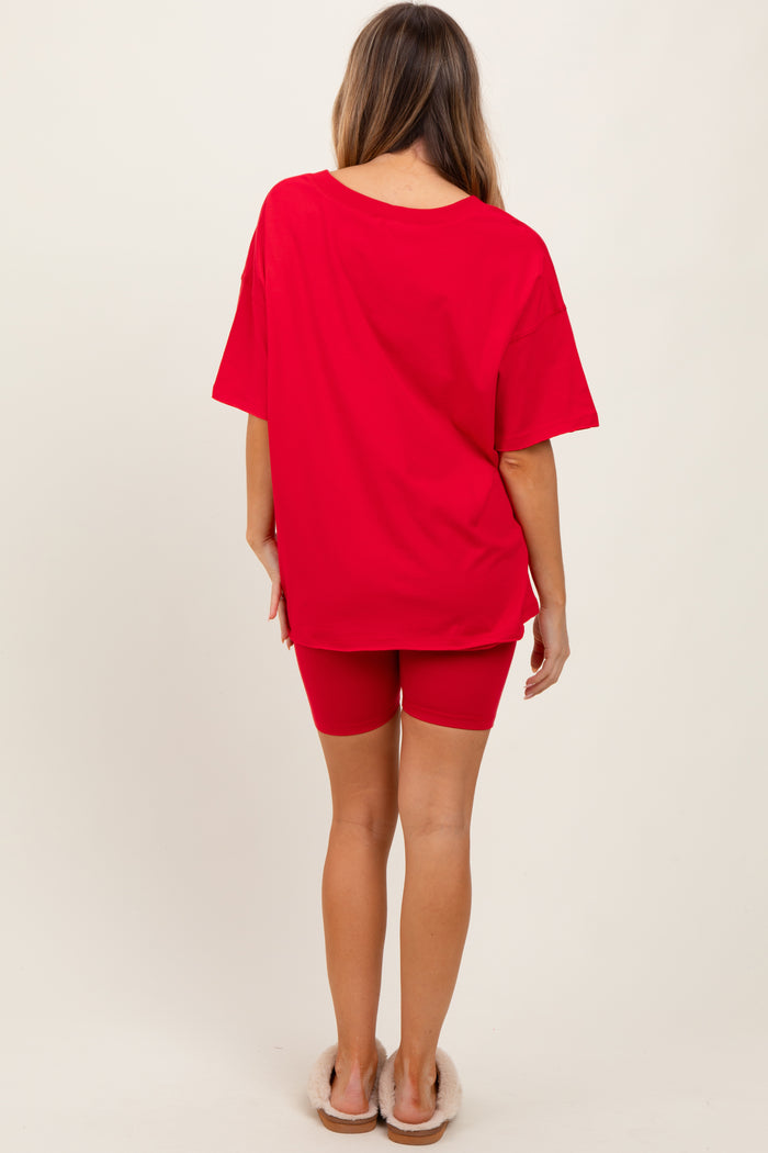 woman wearing a red oversized t-shirt and red cycling shorts, seen from the back