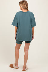 woman wearing a sea green oversized t-shirt with matching shorts, showcasing comfortable maternity loungewear.