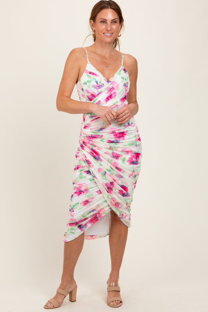 woman wearing a multicolored floral print midi dress with ruching and spaghetti straps
