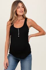 woman wearing a black ribbed maternity tank top with button details and a slight high-low hem, showing a baby bump