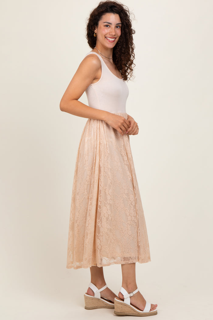 woman wearing a beige fitted tank dress with a lace overlay and white wedge sandals