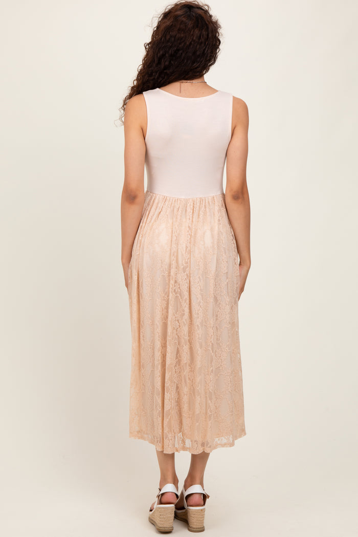 woman wearing a back view of a midi dress with a fitted white top and a sheer lace peach skirt