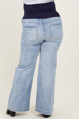 woman wearing light blue maternity plus jeans with a dark blue stretchy waistband, shown from the back