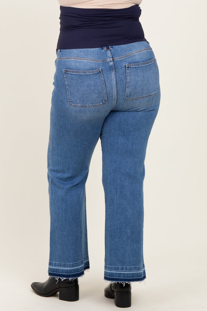 woman wearing a pair of maternity plus size light blue straight-leg jeans, showing the back view with a stretchy waistband