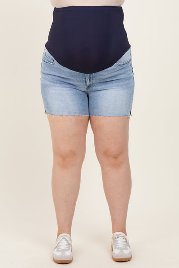 woman wearing dark blue maternity plus denim shorts with a high waistband and frayed hem