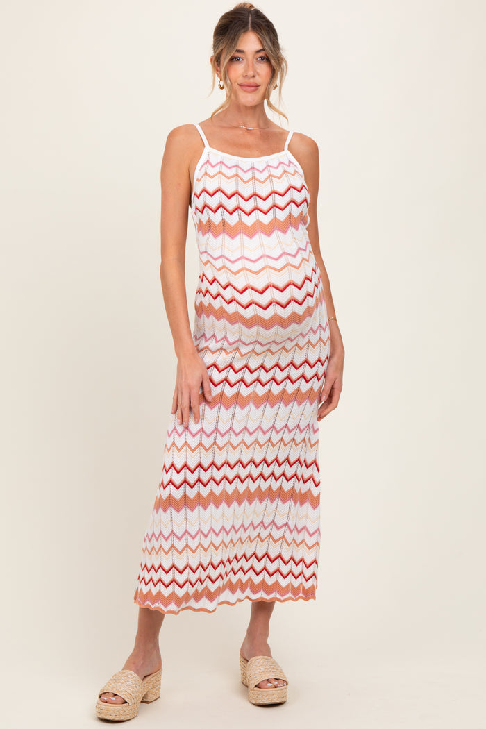 woman wearing a multicolored chevron patterned maternity maxi dress and showing her baby bump