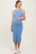 woman wearing a light blue ribbed maternity dress and holding her baby bump
