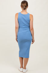woman wearing a light blue ribbed maternity midi dress, showing back view with fitted silhouette
