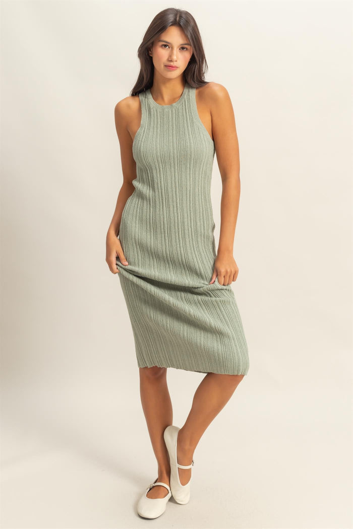 woman wearing a fitted olive green ribbed midi dress with a sleeveless design