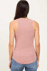 woman wearing a dusty pink ribbed tank top with a rounded hem and racerback style, seen from the back