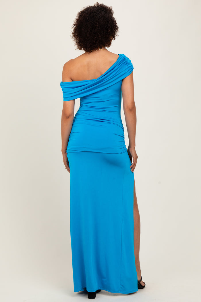 woman wearing a bright blue off-the-shoulder maxi dress with a fitted bodice and side slit, shown from the back