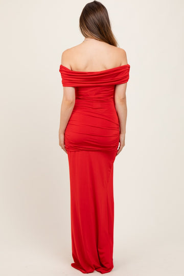 woman wearing a red off-the-shoulder maternity dress with ruched detailing and a fitted silhouette