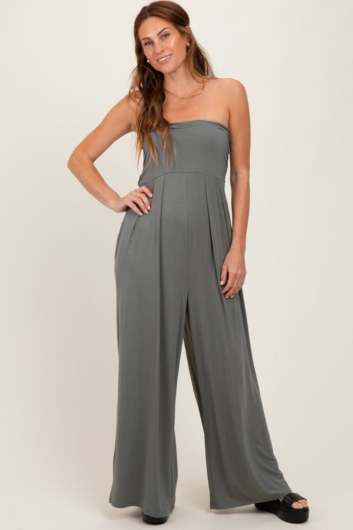 woman wearing a gray strapless jumpsuit with wide legs and a fitted bodice