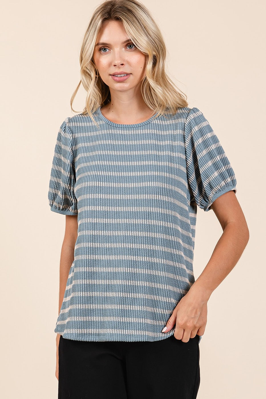 woman wearing a blue and white striped short sleeve top with puff sleeves and a relaxed fit