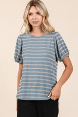 woman wearing a blue and white striped short sleeve top with puff sleeves and a relaxed fit