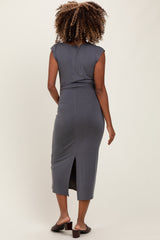 woman wearing a gray cap sleeve maternity dress with a back slit, showcasing a form-fitting style