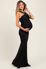 woman wearing a black sleeveless maternity gown with a fitted silhouette and baby bump visible