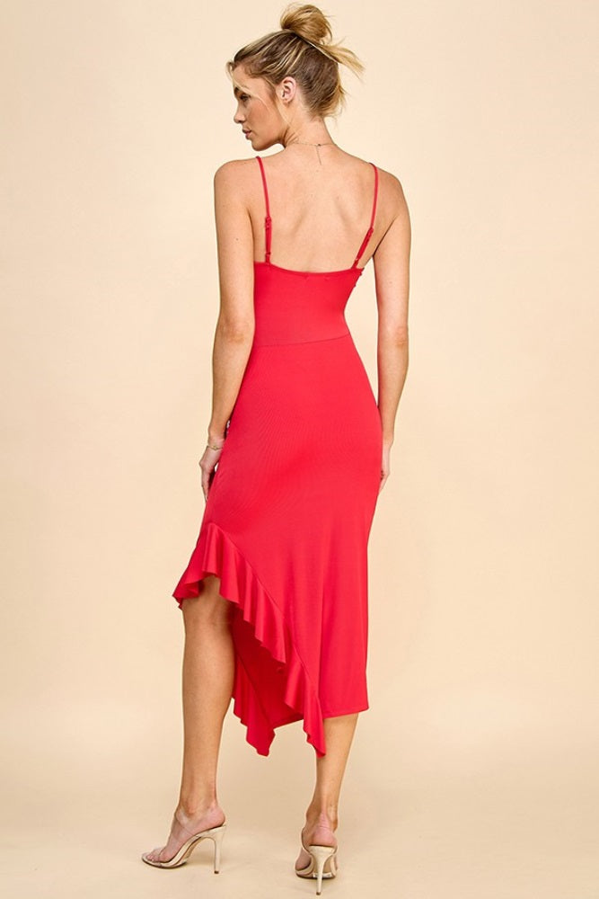 woman wearing a red spaghetti strap dress with a ruffled high-low hem and open back styling