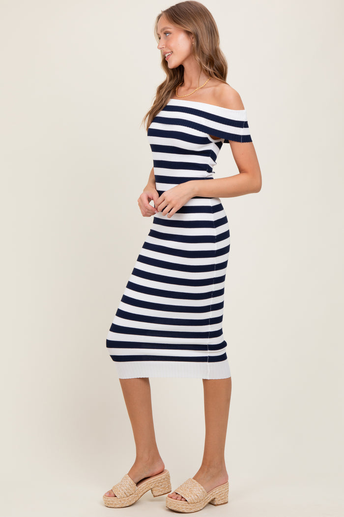 woman wearing a navy and white striped off-the-shoulder midi dress with a fitted silhouette and side slits