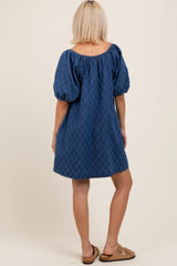 woman wearing a blue puff sleeve maternity dress with a loose fit, shown from the back