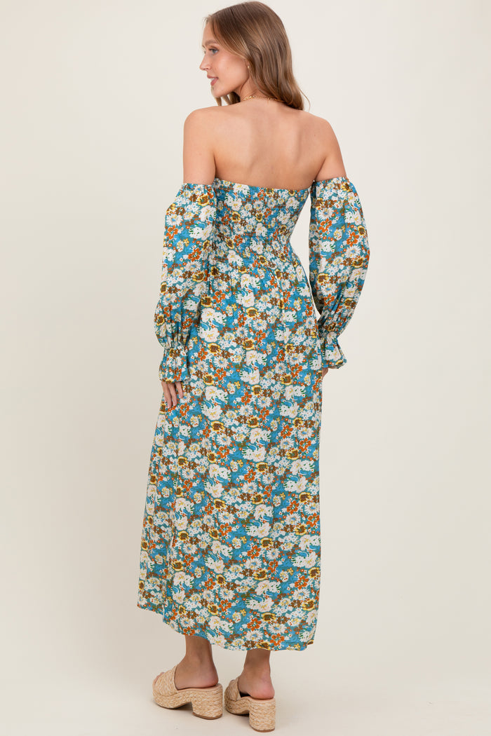 woman wearing a long off-the-shoulder floral maxi dress with puff sleeves and a fitted bodice