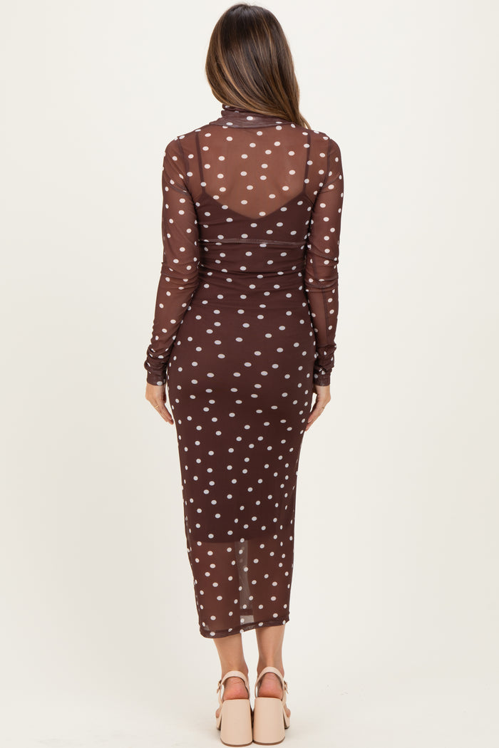 woman wearing a sheer brown polka dot maternity dress with long sleeves and a fitted silhouette