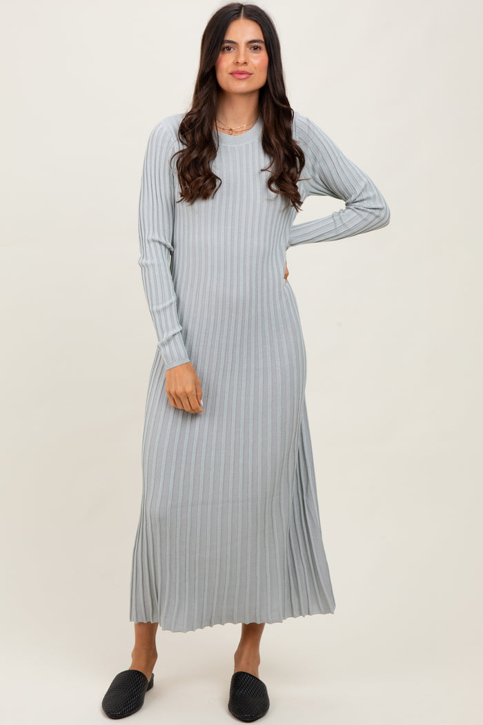 woman wearing a light gray ribbed long sleeve maxi dress and black slip-on shoes