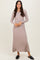 woman wearing a ribbed beige long sleeve maxi dress and black slip-on shoes