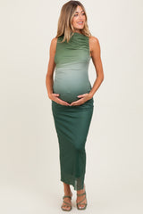 woman wearing a green ombre maternity dress with a fitted silhouette, holding her baby bump