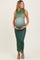 woman wearing a green ombre maternity dress with a fitted silhouette, holding her baby bump