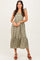 woman wearing a green and white gingham midi dress with a ruffled hem and shoulder straps