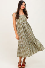 woman wearing a green and beige checkered maxi dress with puff sleeves and a tiered hem