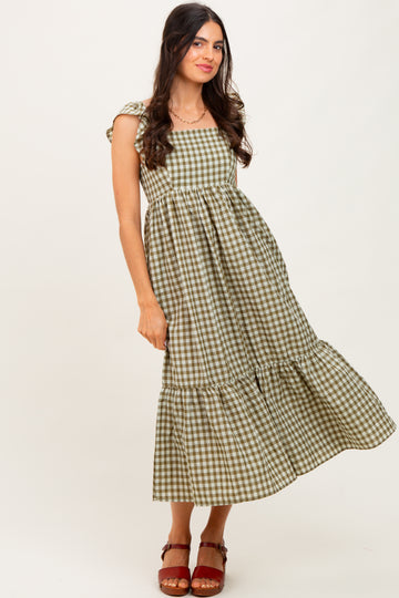 woman wearing a green and beige checkered maxi dress with puff sleeves and a tiered hem