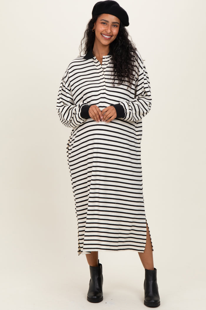 woman wearing a black and white striped maternity dress with side slits and long sleeves, showcasing her baby bump