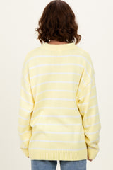 woman wearing a yellow and white striped oversized sweater, viewed from the back