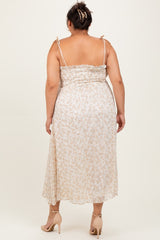 woman wearing a light floral plus-size midi dress with adjustable straps and a smocked bodice, viewed from the back