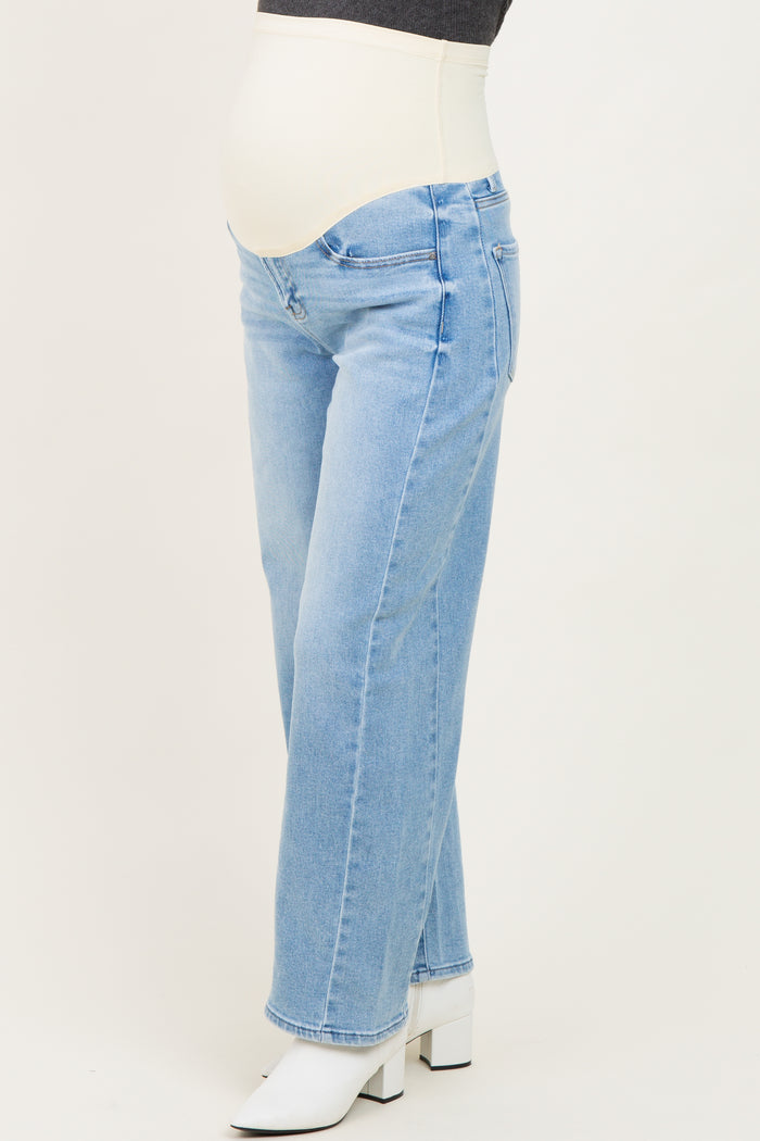 maternity wear light blue straight leg jeans with a stretchy panel, worn by a model showing a baby bump