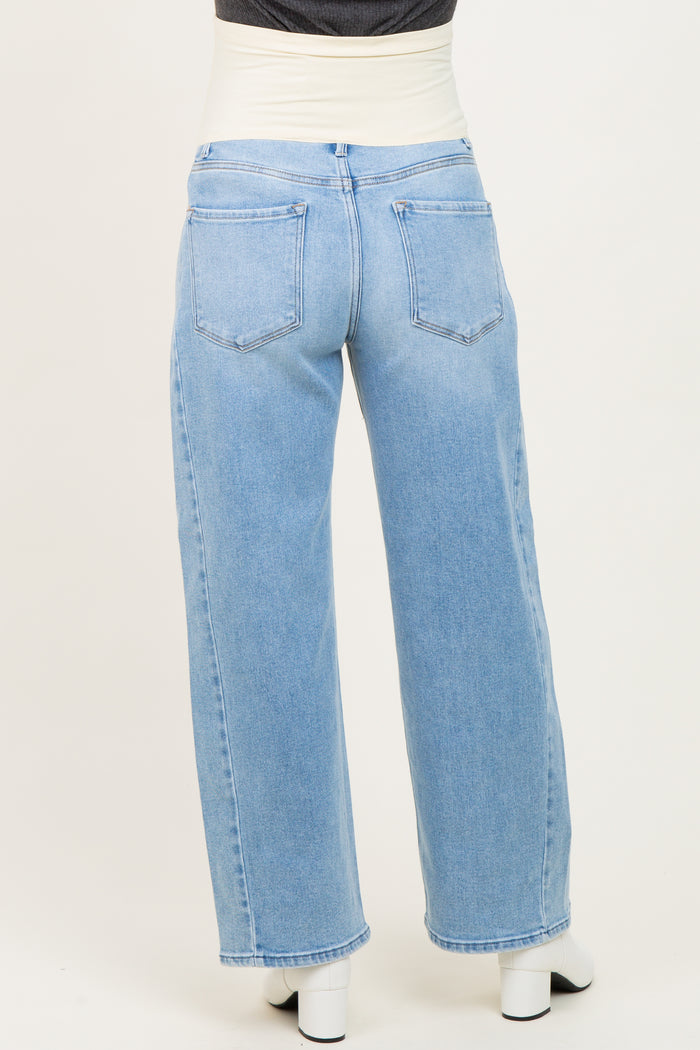woman wearing light blue wide-leg maternity jeans with a supportive waistband, shown from the back