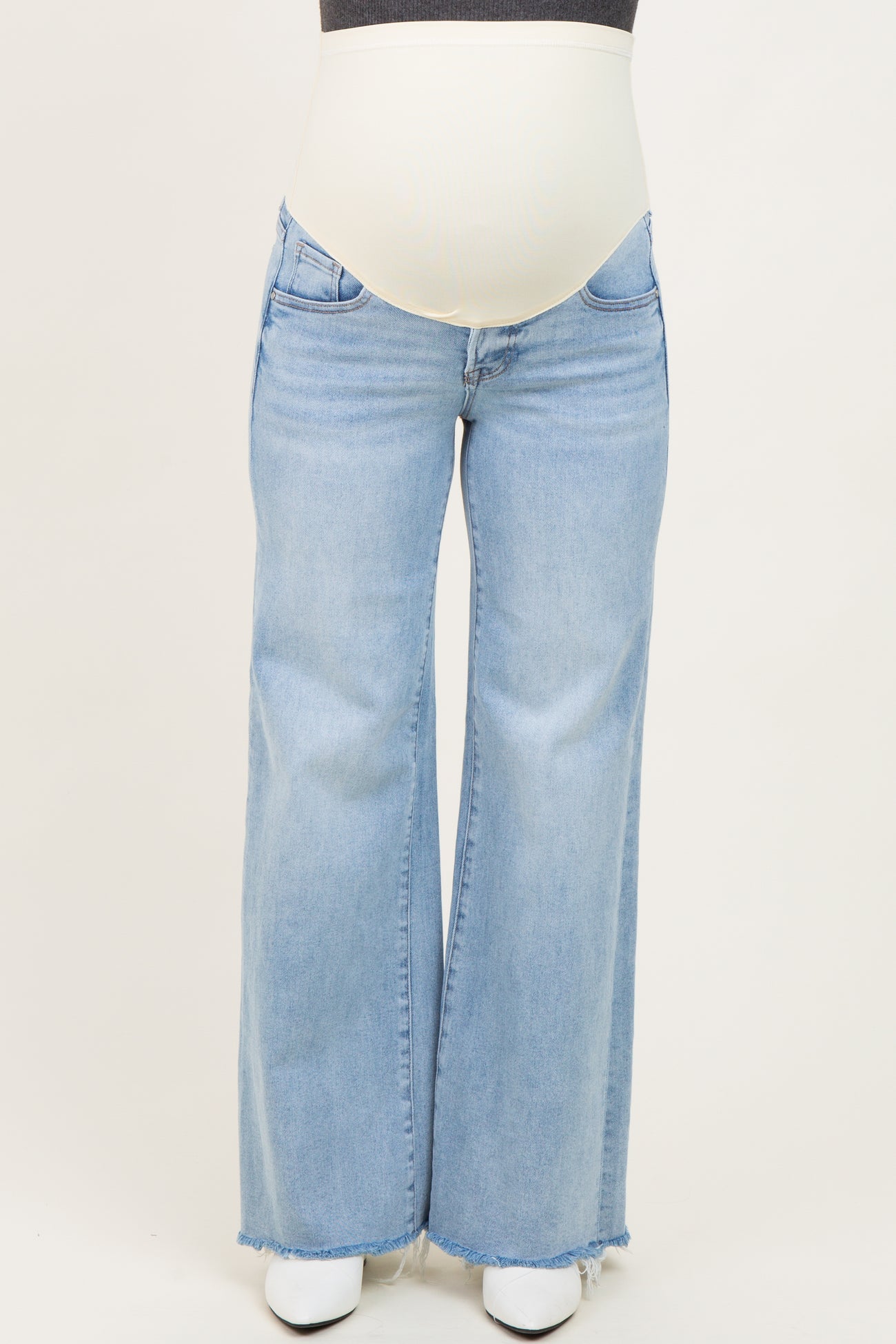 maternity wear light blue flared jeans with a stretchy waistband and visible baby bump