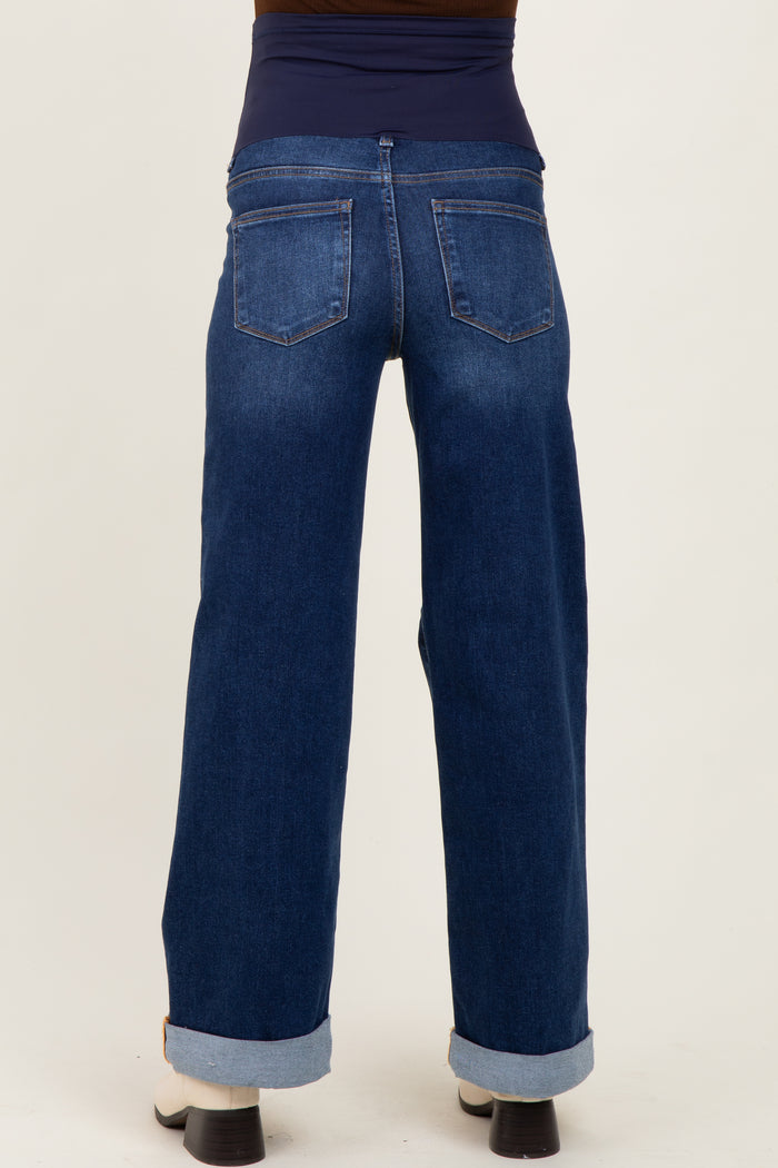 woman wearing dark blue maternity wide-leg jeans with a stretchy waistband and rolled cuffs from the back
