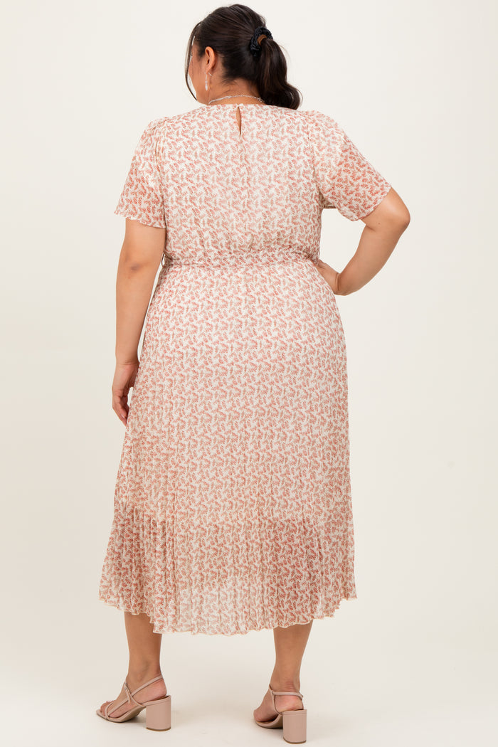 woman wearing a light pink plus size maxi dress with a floral pattern and short sleeves, seen from the back